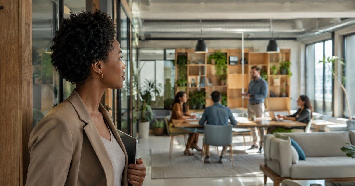A professional observing how a team works together in a modern workplace